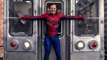 A smiling man as Spider-Man holding two halves of a subway train together with his arms